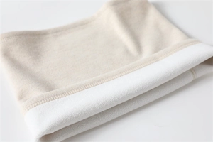 Close-up of beige knitted neck warmer with soft white fleece lining for winter warmth