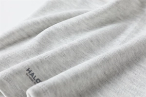 Close-up of grey marl knitted fabric texture with HALO OUTDOOR CLUB logo print