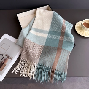 Close-up of a plaid cashmere scarf with soft tassels in beige, blue, and brown tones