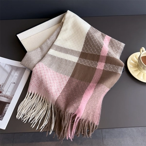 Close-up of pastel plaid cashmere-feel scarf with long fringe details and woven texture