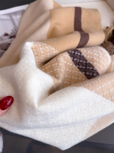Close-up of soft waffle texture plaid scarf with elegant beige and brown tassel details