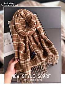 Detail of warm brown plaid cashmere scarf with soft tassels in a premium gift box