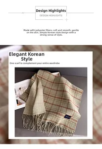 Detail of beige and orange plaid cashmere-like scarf with soft fringe and dual pattern