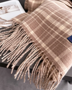 Close-up of brown and beige plaid cashmere-feel scarf with elegant long tassel details