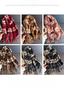 Detail view of fringed plaid scarves in six classic colors showing warm knit texture