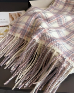 Close-up of elegant plaid scarf with fringe details and soft cashmere-like texture