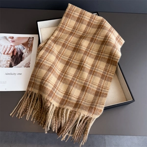 Detail of elegant plaid scarf with long tassels in khaki brown cashmere-like texture