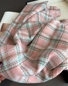 Close-up of pink and blue plaid scarf showing soft faux cashmere texture and weave