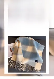 Detailed view of blue and grey plaid scarf texture with soft polyester fiber material