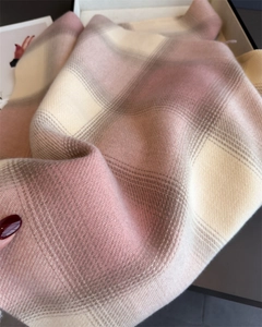 Close-up detail of soft plaid cashmere-like scarf with fringe and diagonal weave texture