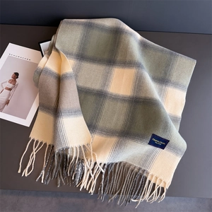 Detailed view of vintage plaid cashmere-feel scarf with elegant tassels and woven texture