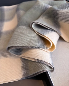 Close-up of soft plaid scarf showing thick twill weave texture and green cream fringe