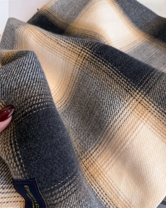 Macro shot of plaid scarf showing diagonal weave texture and contrast color grid