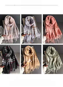 Macro detail of soft plaid scarves showing fluffy texture and elegant fringe edges