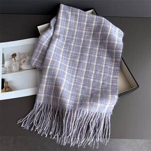 Detailed view of purple plaid scarf with soft fringe edges in elegant gift box