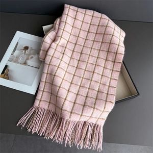 Detail of pink and brown plaid cashmere-like scarf with soft fringe and luxury texture