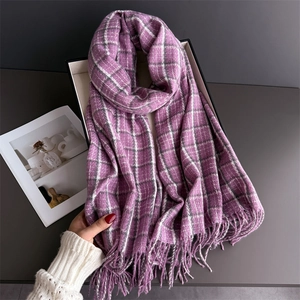 Detail of purple plaid cashmere-feel scarf with soft fringe tassels in a display box