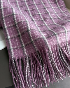 Close-up of vintage purple plaid scarf with delicate tassels and cashmere-like texture