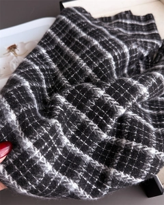 Close-up of classic black and white plaid scarf with a soft brushed cashmere-like texture