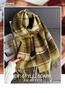 Detail of soft cashmere-like dark green and beige plaid scarf with fringe tassels