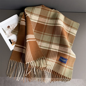 Close-up of retro plaid scarf showing thick texture, fringe edges and elegant woven label