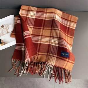Detailed view of British plaid scarf fringe tassels and soft faux cashmere fabric texture