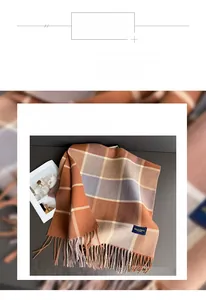 Detail of soft orange and purple plaid scarf fabric with elegant tassel fringe finish