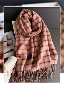 Detailed view of soft pink plaid cashmere-like scarf with elegant fringe trim details