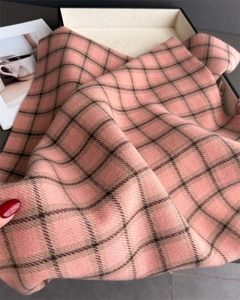 Close-up of soft plaid scarf fabric in pink and brown with fine cashmere-like texture