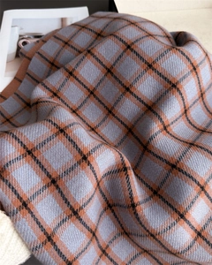 Close-up of blue and orange plaid cashmere-like scarf showing soft twill texture
