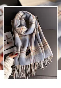 Detail of blue and beige plaid faux cashmere scarf with soft long fringe tassels