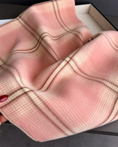 Close-up of pink and beige plaid scarf showing soft brushed cashmere texture details