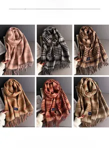 Detail showing various plaid patterns and soft tassels of the cashmere-style scarf
