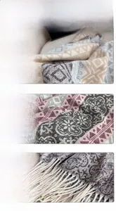 Detailed view of bohemian floral print scarf featuring pink grey tones and long tassel edges