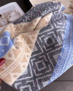 Macro shot of ethnic geometric knit texture and soft fringe on bohemian winter scarf