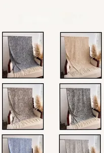 Detail view showing assorted paisley patterns and fringe edges on various cashmere scarves
