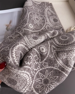 Close-up of paisley pattern on bohemian cashmere shawl with fringe texture details