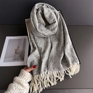 Elegant grey paisley cashmere shawl with fringe tassels and warm winter knit texture