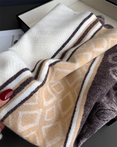 Detailed close-up of patterned winter scarf showing cashmere-like texture and floral motifs
