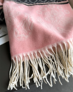 Detail of pink and grey floral jacquard scarf with thick fringe and soft texture