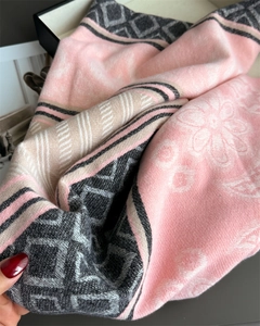 Detailed macro view of soft cashmere-feel scarf showing pink and grey floral patterns