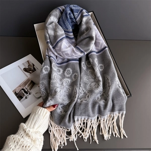 Detail of floral and geometric pattern scarf with fringe, textured cashmere-like fabric