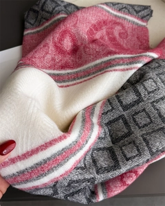 Detail of pink and grey geometric woven scarf fabric with soft cashmere-like texture