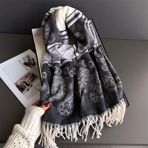 Detailed texture of floral knit scarf featuring elegant fringes and abstract patterns