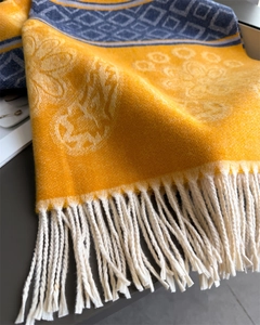 Detail of yellow floral and navy geometric pattern scarf with thick cream fringe trim