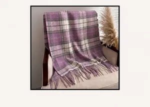 Detail of purple plaid cashmere-style scarf with soft fringe on an armchair