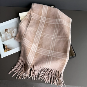Close-up of checkered tassel scarf in soft pink and beige with premium gift box