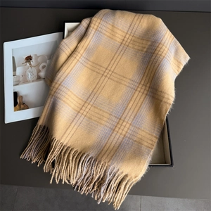 Detail of yellow and grey checkered scarf with soft fringe tassels in a gift box