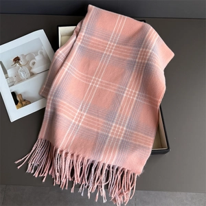 Detailed view of soft pink and gray plaid scarf with elegant fringed edges decoration