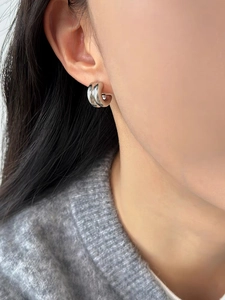 Close-up of minimalist double C-shaped S925 silver earrings worn by a model